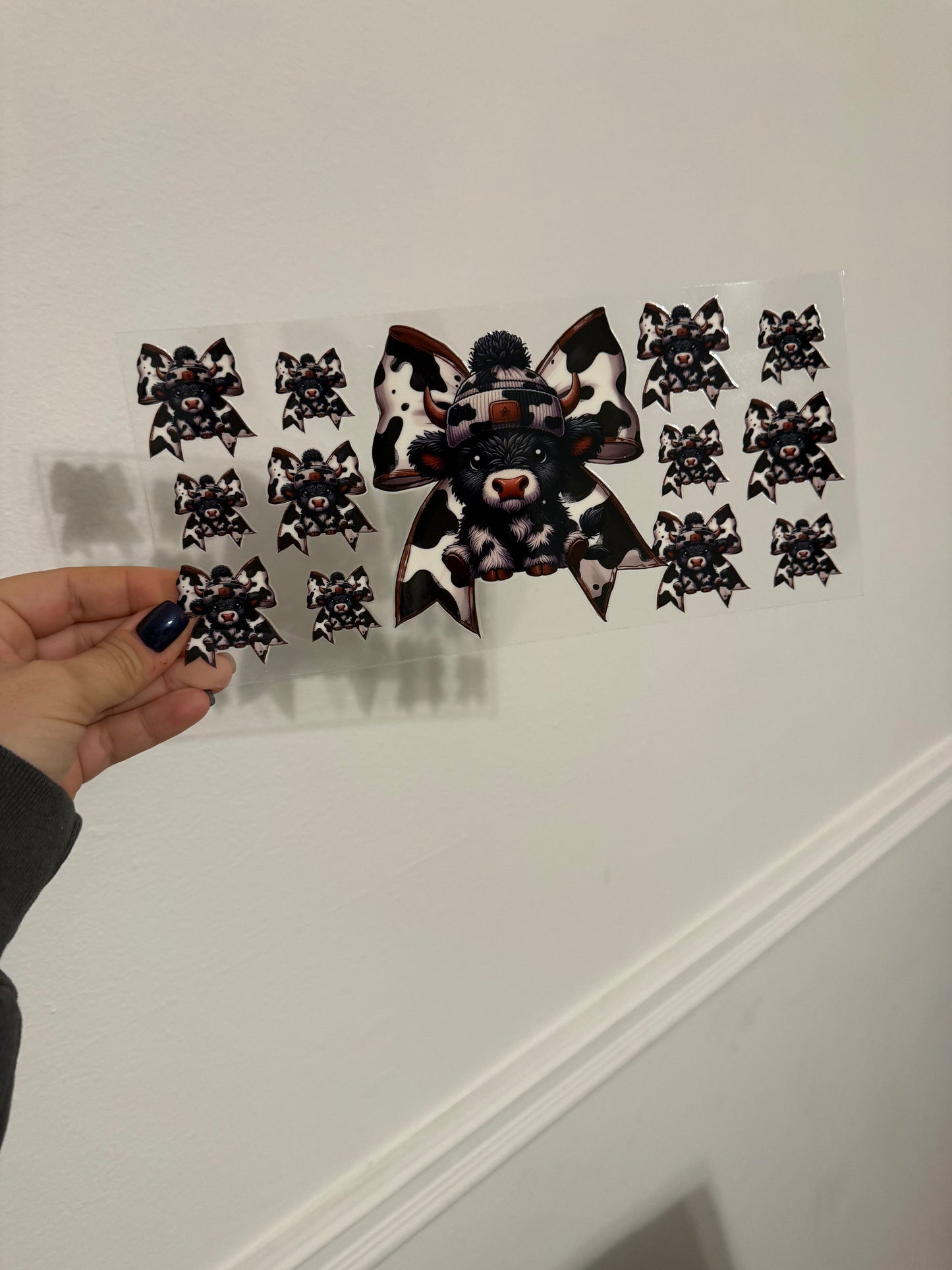 black cow with bows