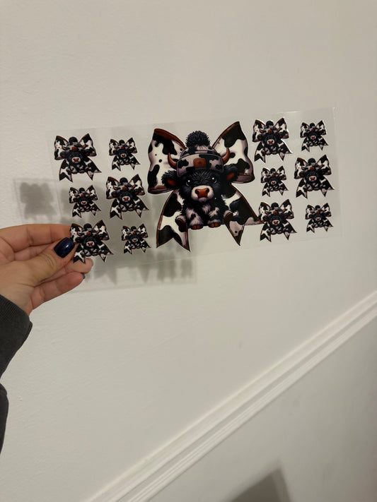 black cow with bows