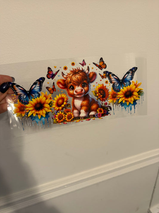Highland cow with butterflies